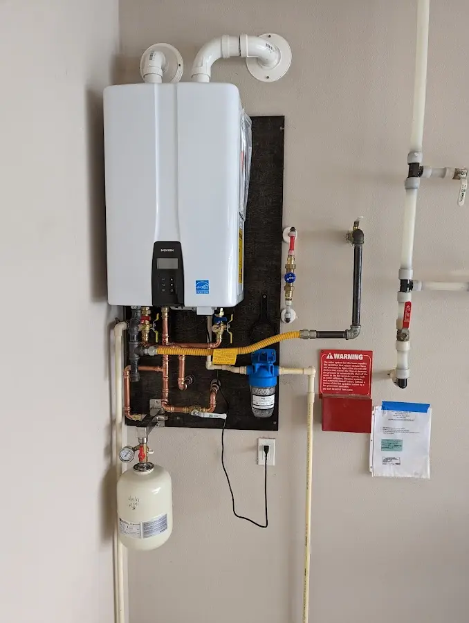 Professional plumber installing copper piping in a Bellingham home